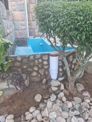 Reservoir dam with natrual stone cladding and auto topup from gutters